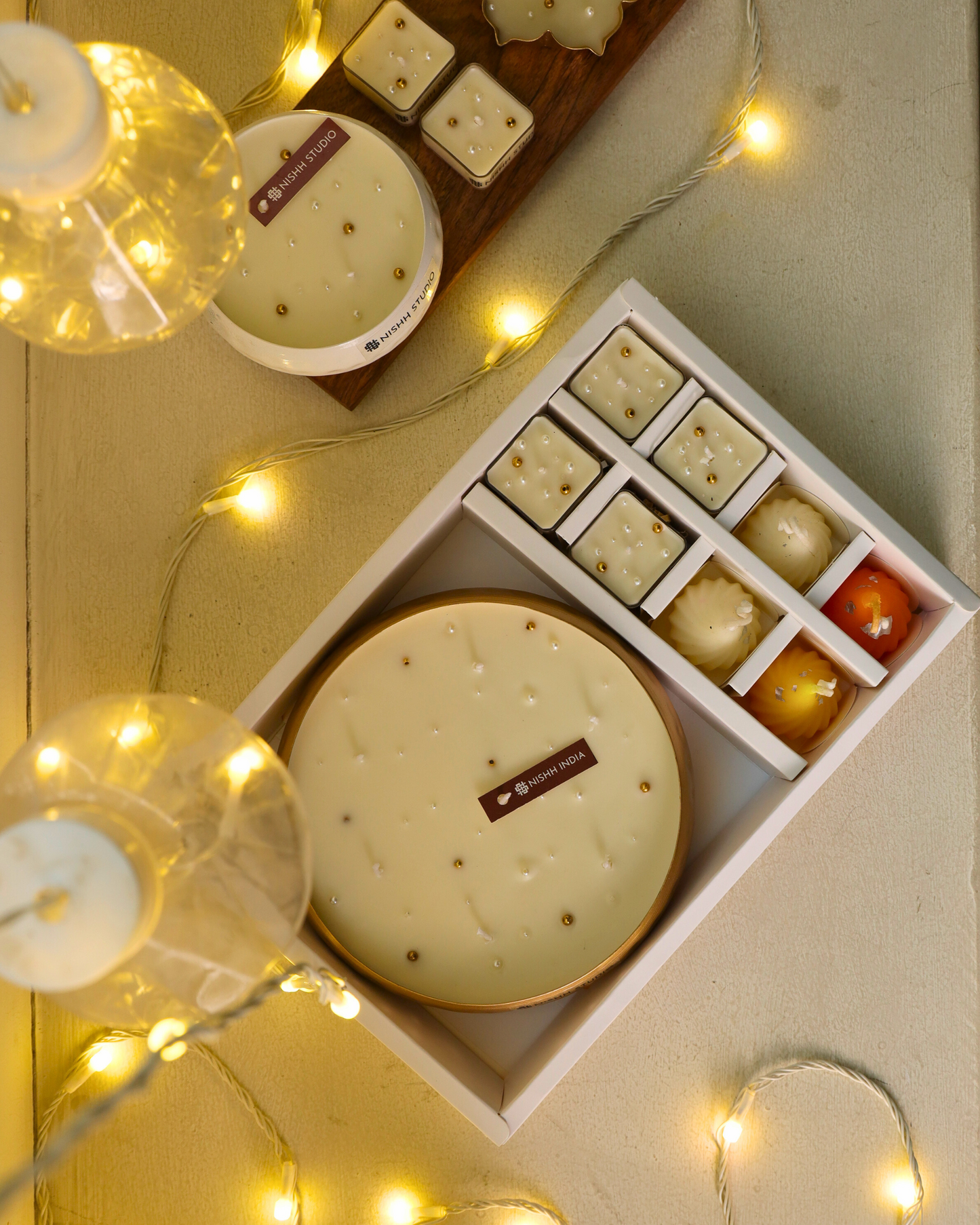 Four laddoo/modak candles symbolizing festivity and prosperity – part of Mukta Luxe Gift Hamper.