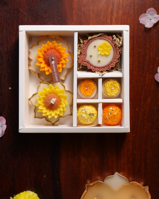 Arka Gift Set with sunflower urli candles, modak candles, tealights and floral diya – luxury festive hamper.