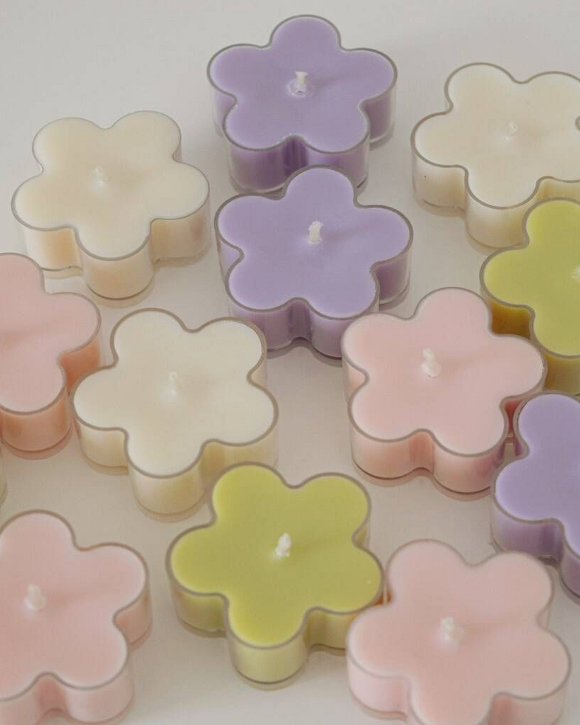 Nine-piece Blossom floral scented tea-light candles, handcrafted from pure soy wax, ideal for peaceful meditation ambience and intimate dinner decor.