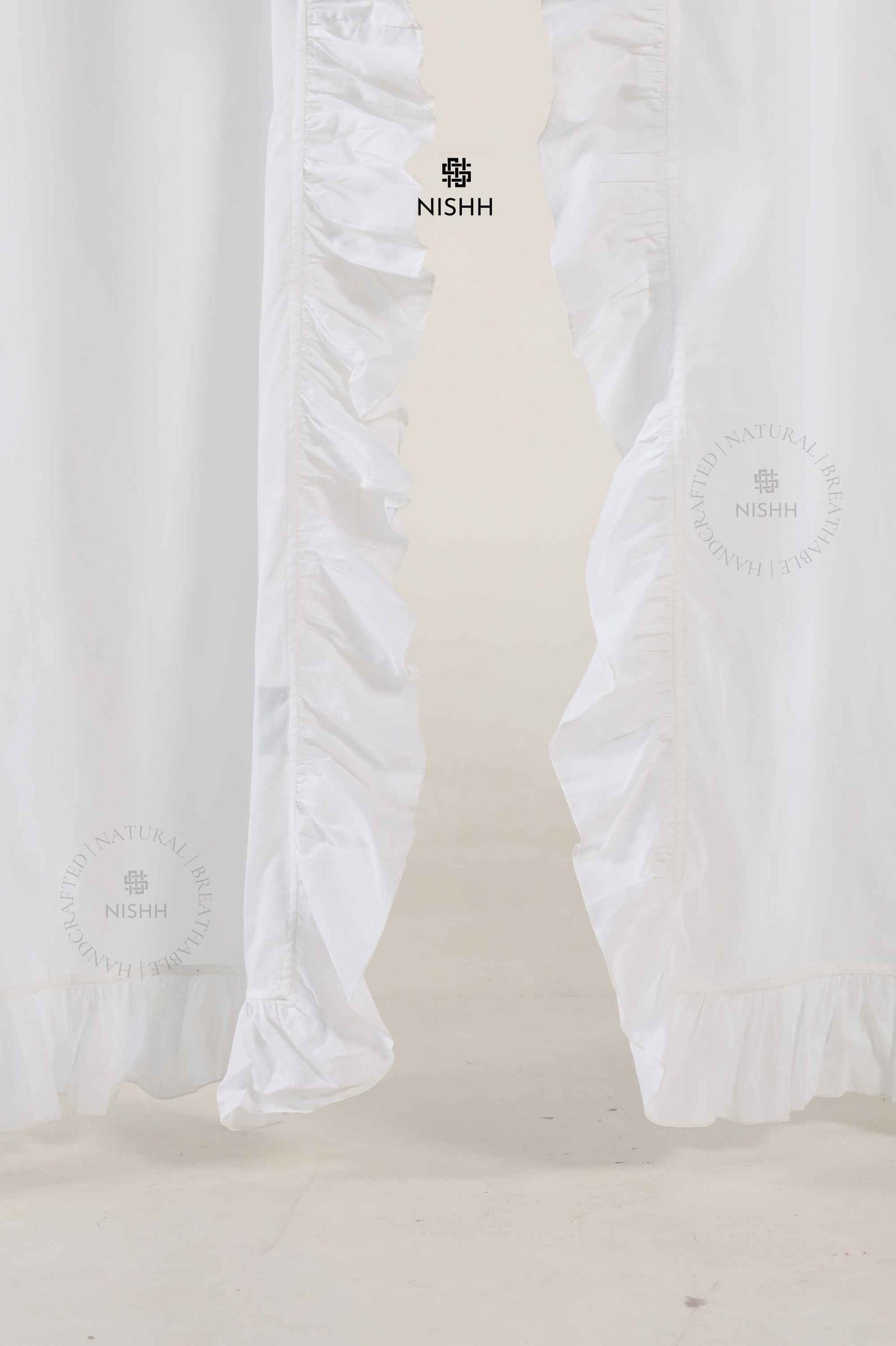 Custom size Calmcrest linen drapes with soft ruffles styled in a bedroom