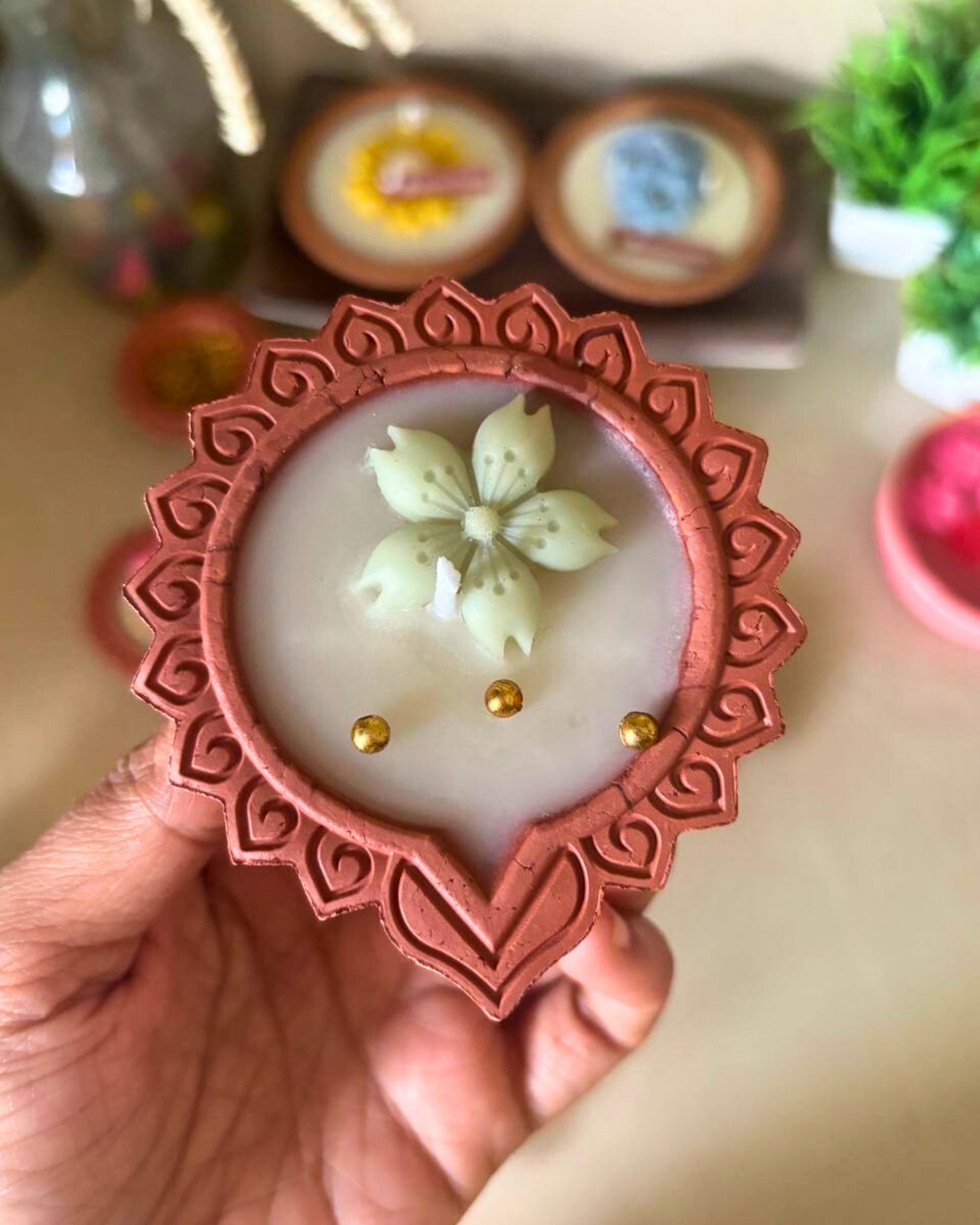 Traditional diya-shaped candle with elegant floral detailing for puja and Diwali décor.