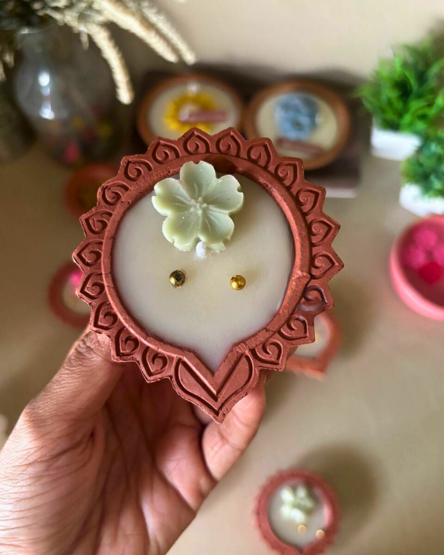 Eco-friendly soy wax floral diya candle with decorative flower detailing.