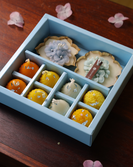 Two laddoo-inspired candles symbolizing joy and festivity – part of Shubh Aarambh Gift Set.