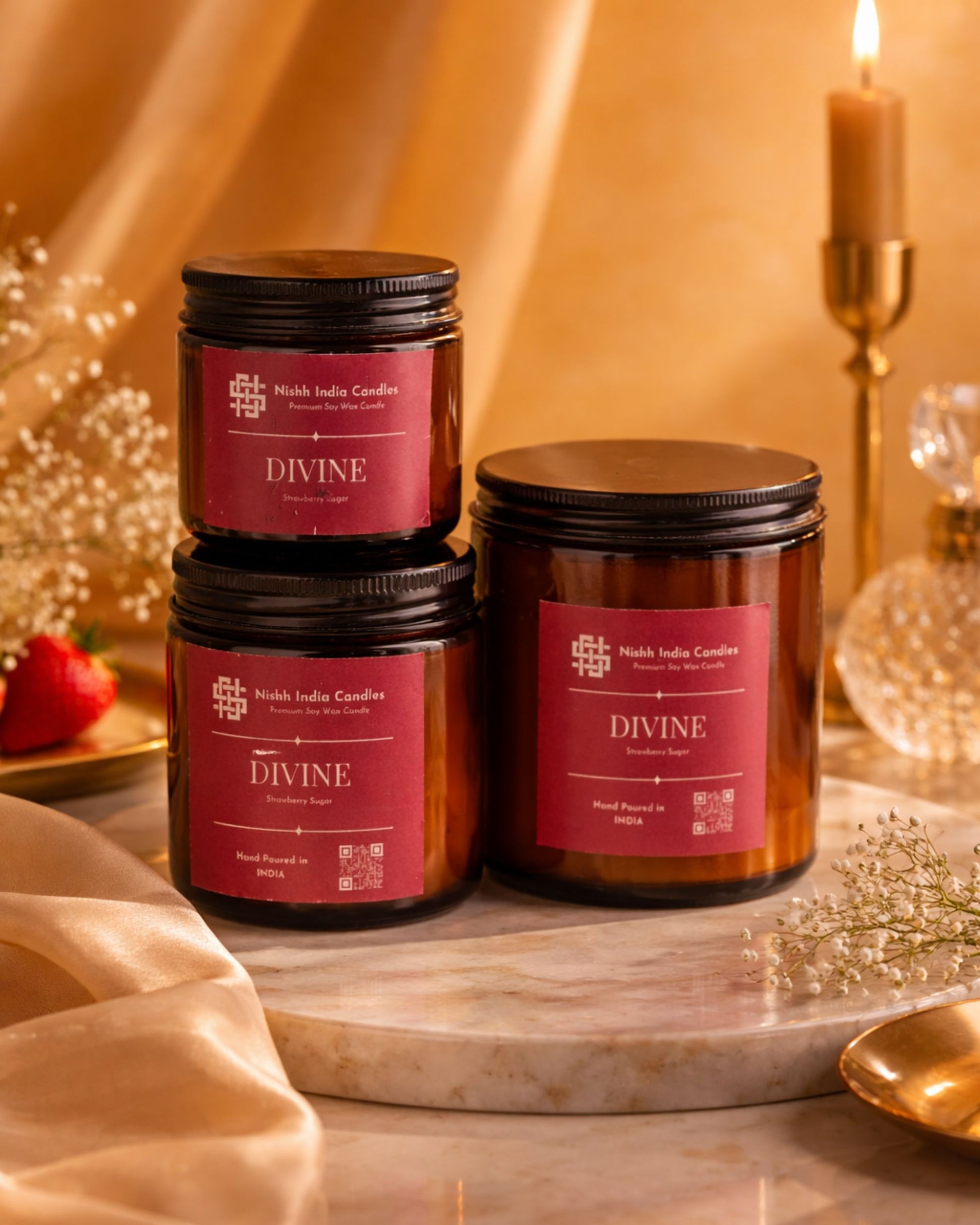 Nishh Divine Strawberry Sugar soy wax candle in amber jar styled in luxury marble setup with warm golden lighting for premium home decor.
