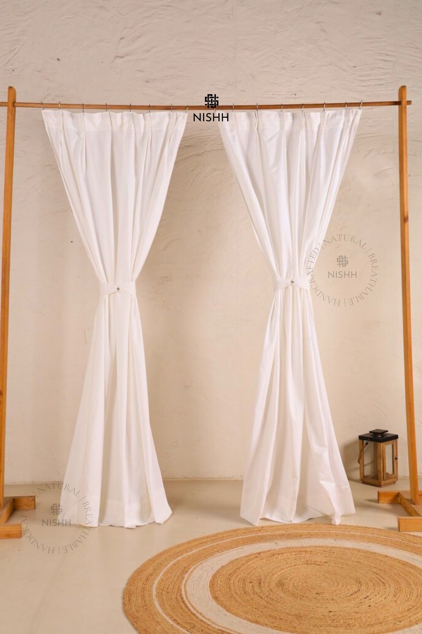 Full view of double pinch pleat sheer linen curtains in a minimal interior