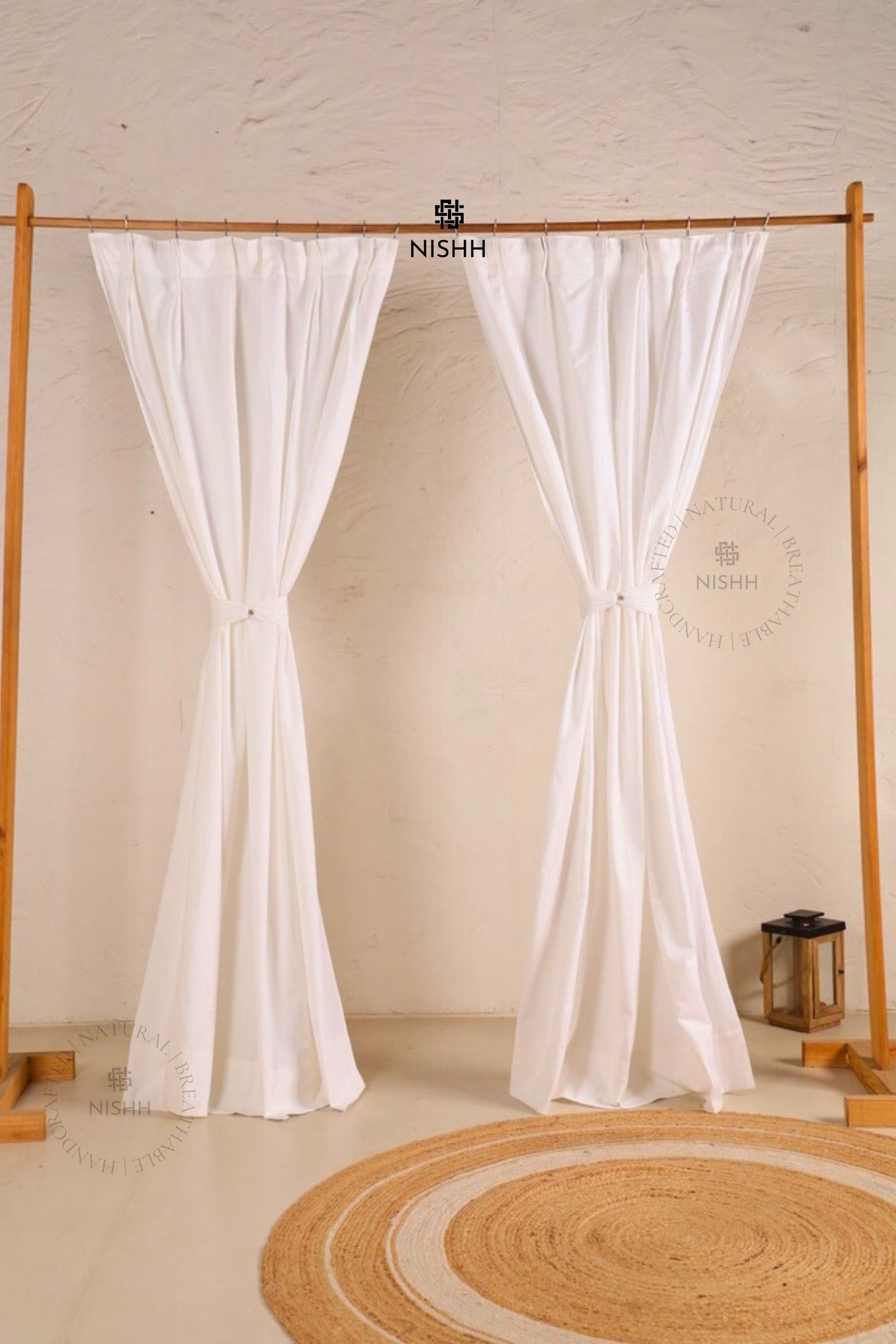 Full view of double pinch pleat sheer linen curtains in a minimal interior