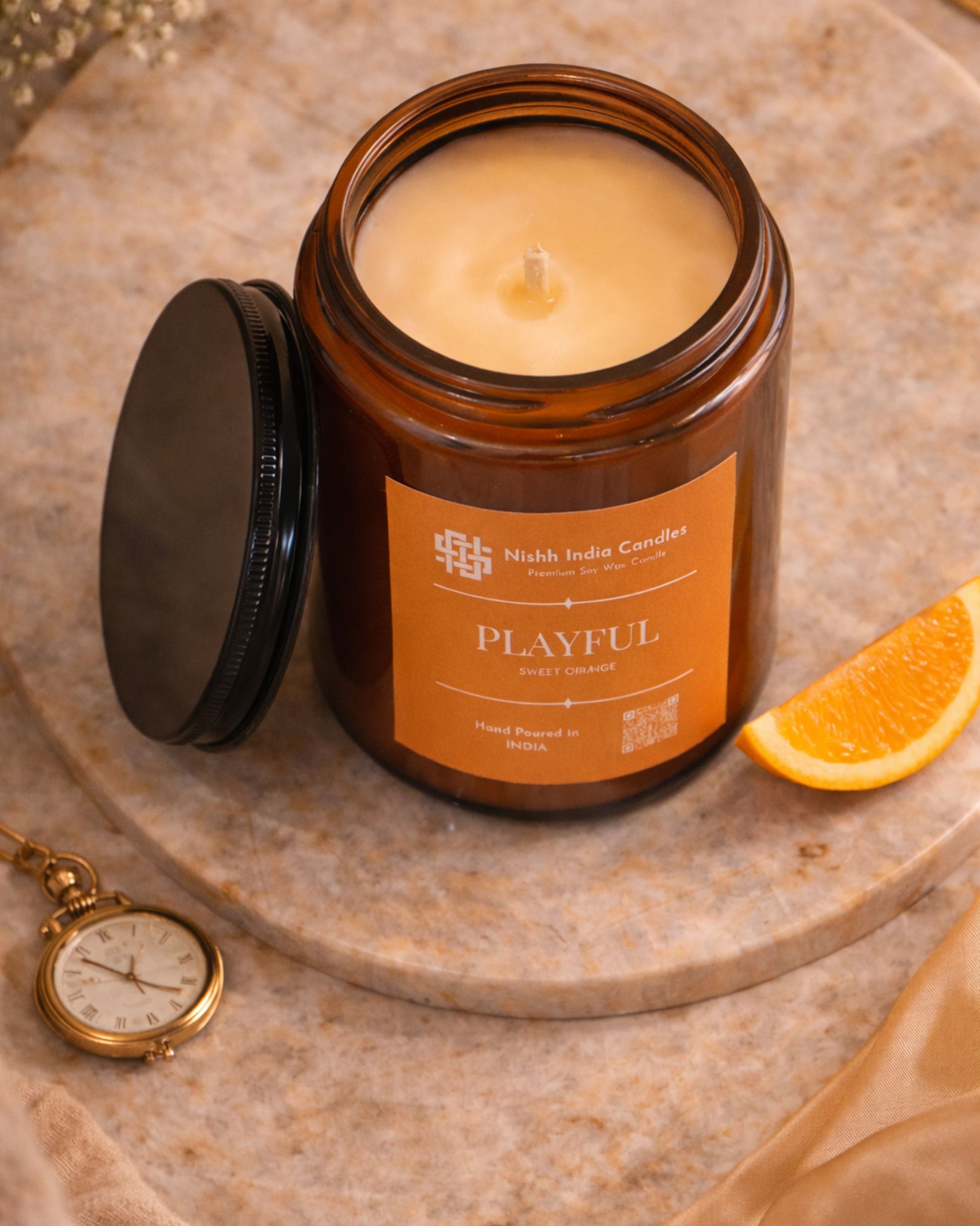 Nishh India Sweet Orange premium soy candle gift packaging styled in luxury setup perfect for gifting and festive occasions