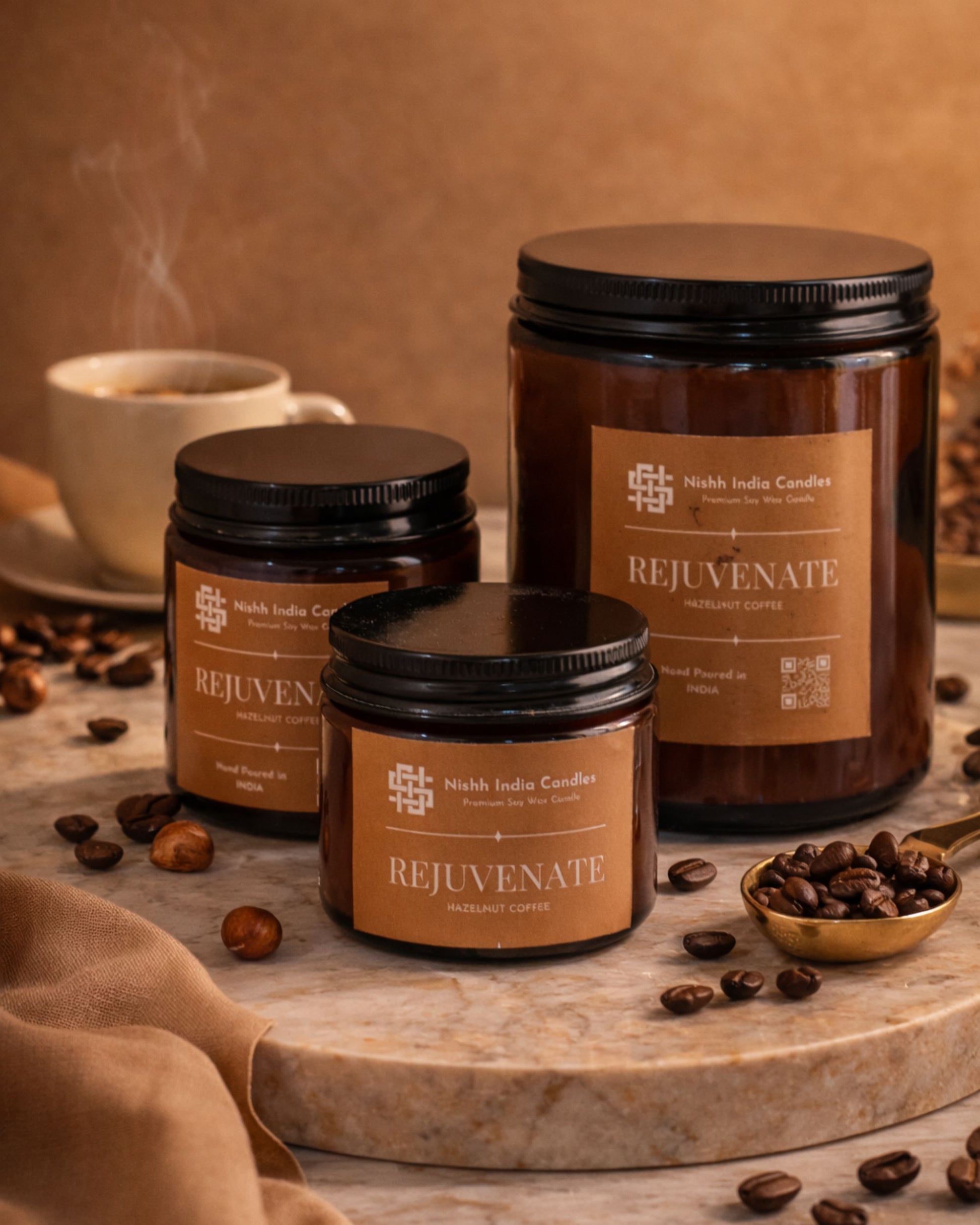 Nishh India Rejuvenate Hazelnut Coffee soy candle collection in multiple amber jar sizes displayed in luxury warm setup