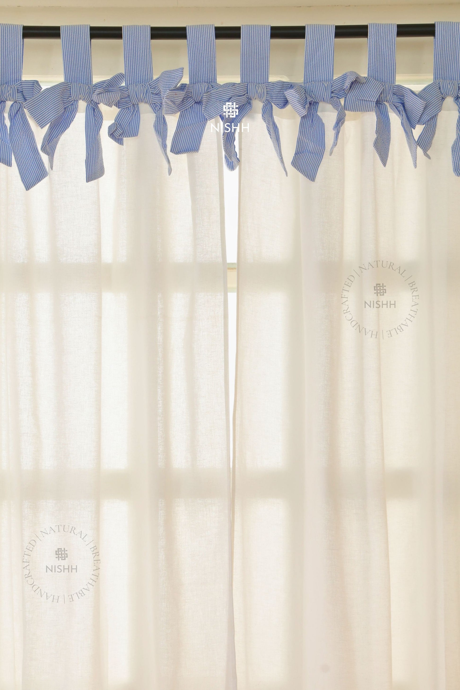 Sheer linen curtains allowing soft natural light in a minimal home interior