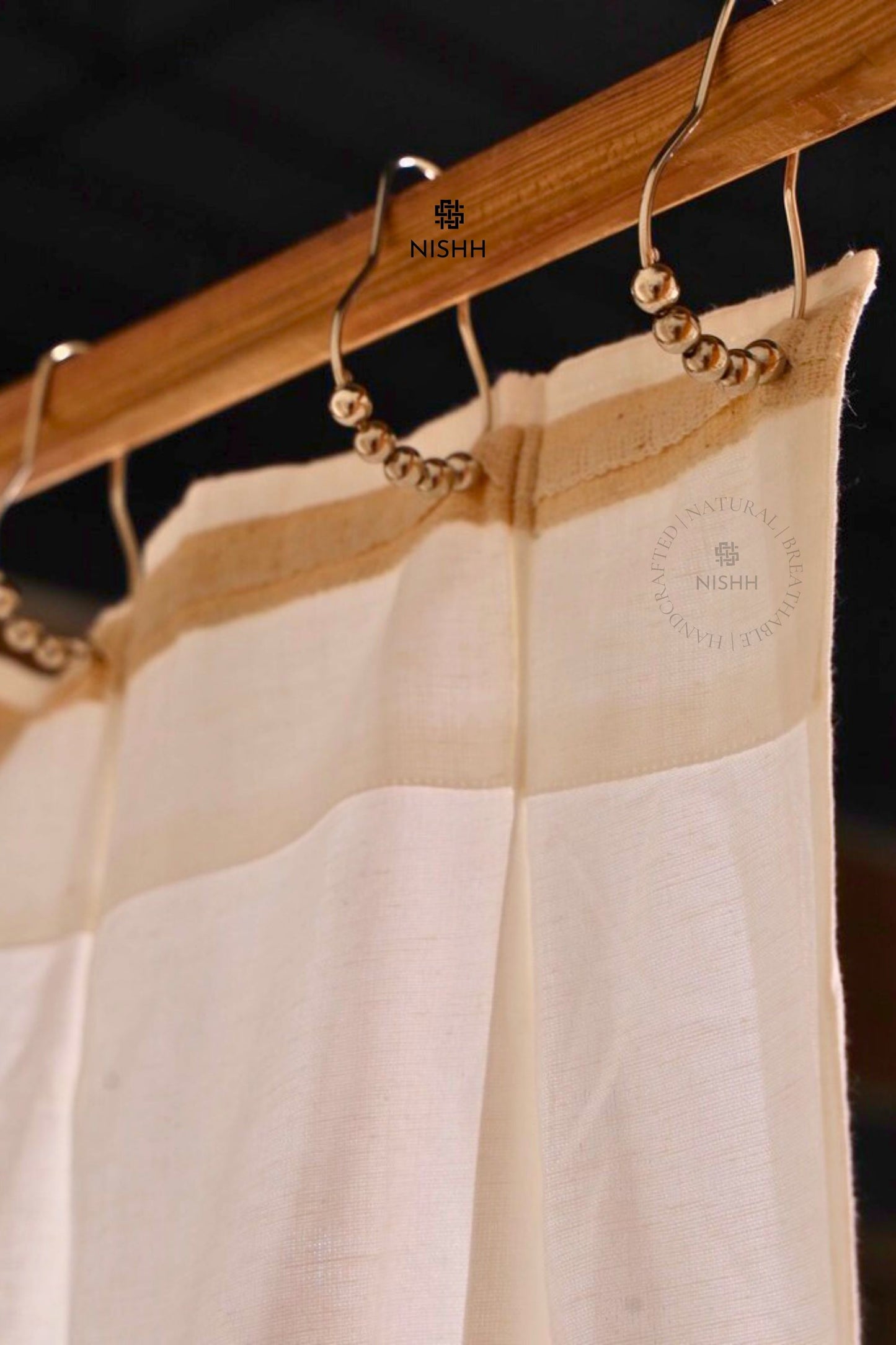 White linen curtains with tailored pleats styled in a luxury living space