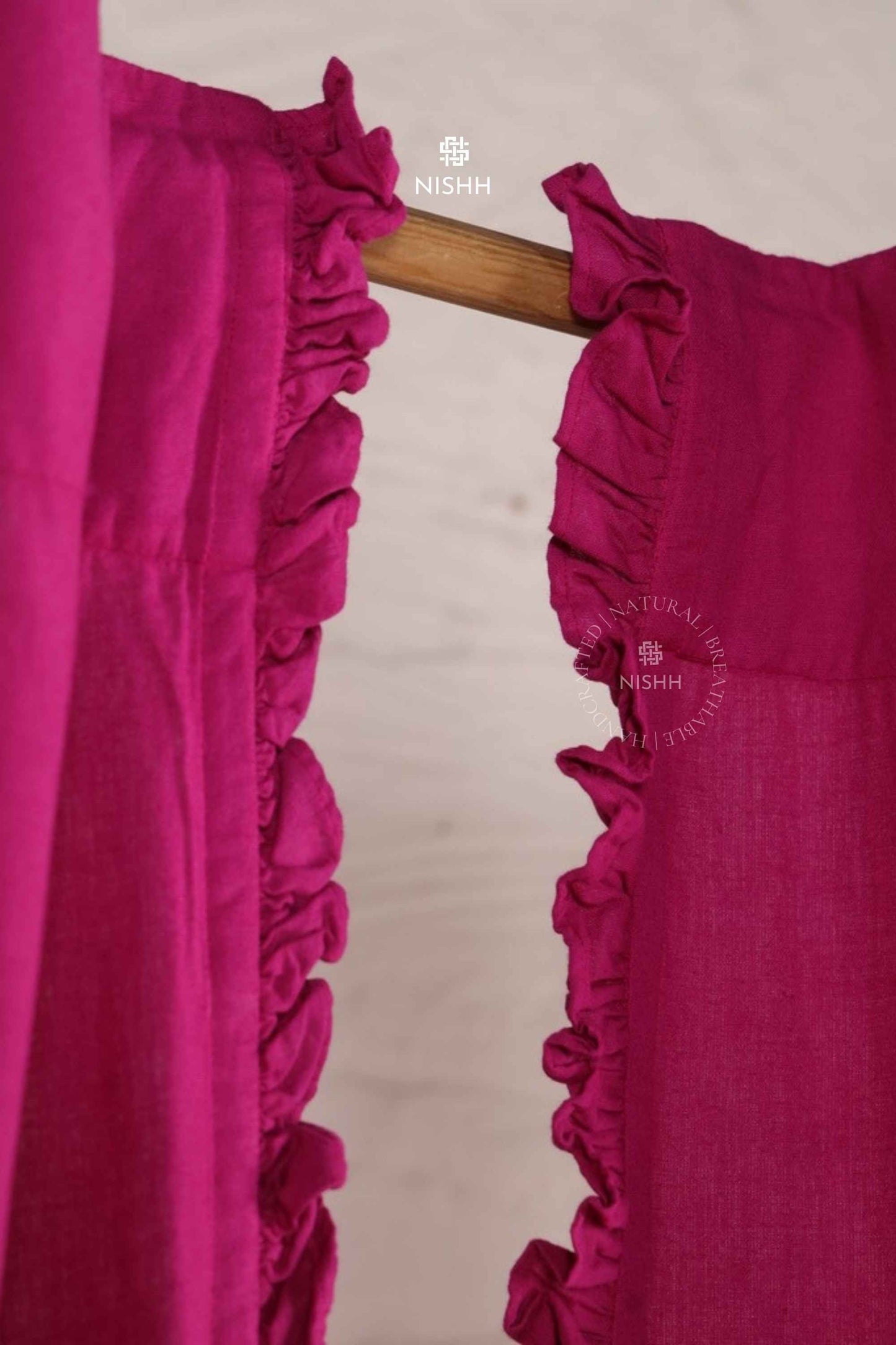 Plume linen drapes with soft frill movement styled in a serene bedroom