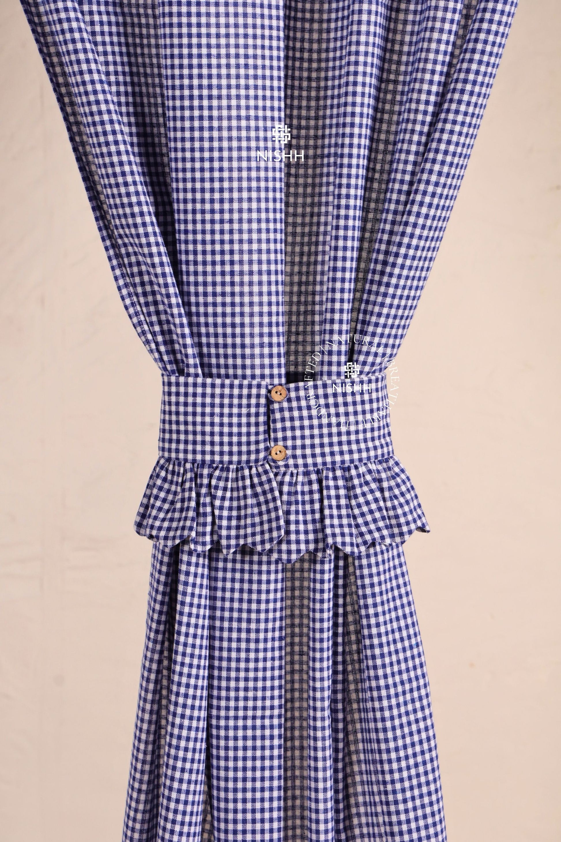 Blue gingham cotton curtains styled with matching fabric tiebacks