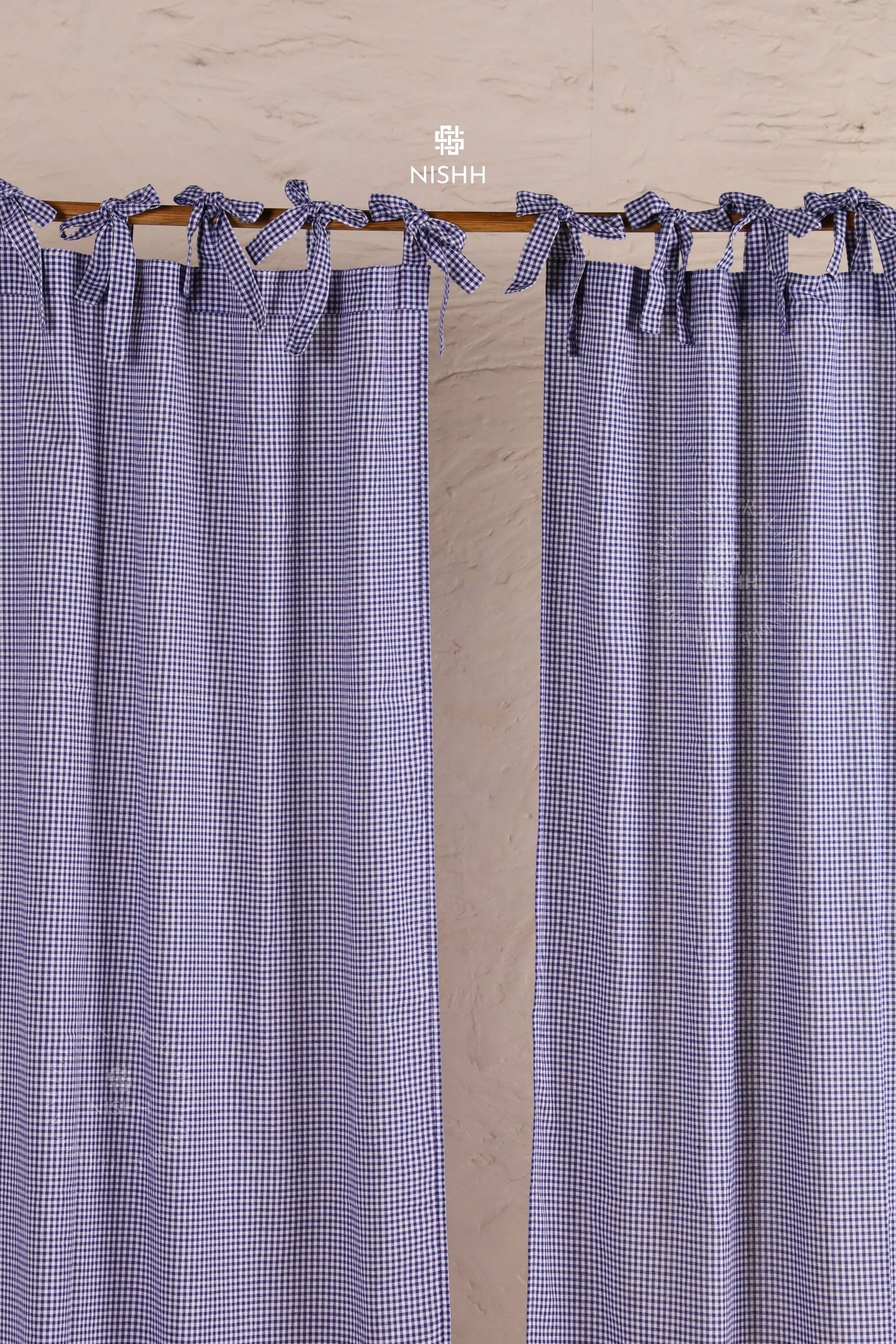 Handcrafted gingham curtains styled in a minimal living room