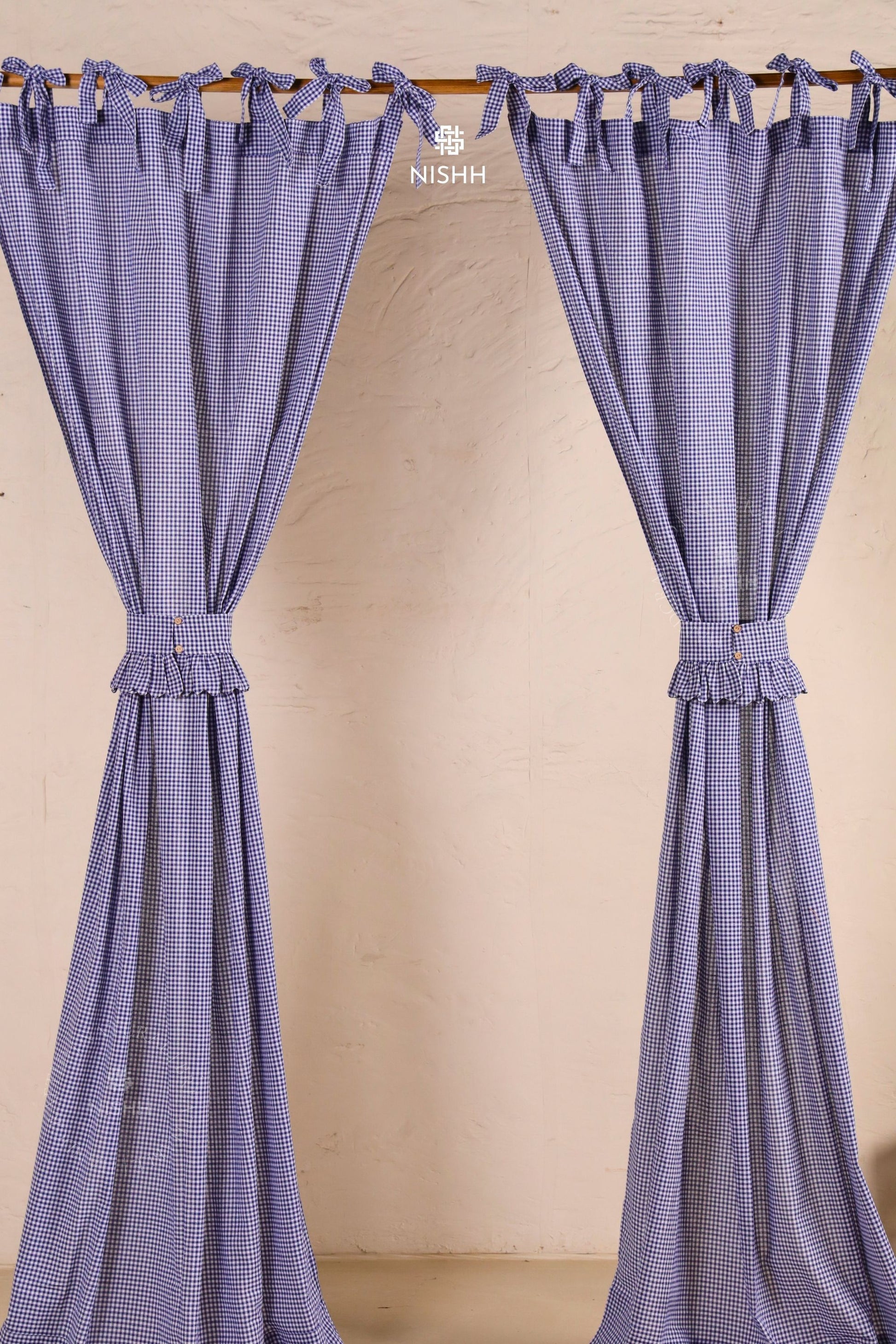 Blue gingham cotton curtains styled with matching fabric tiebacks