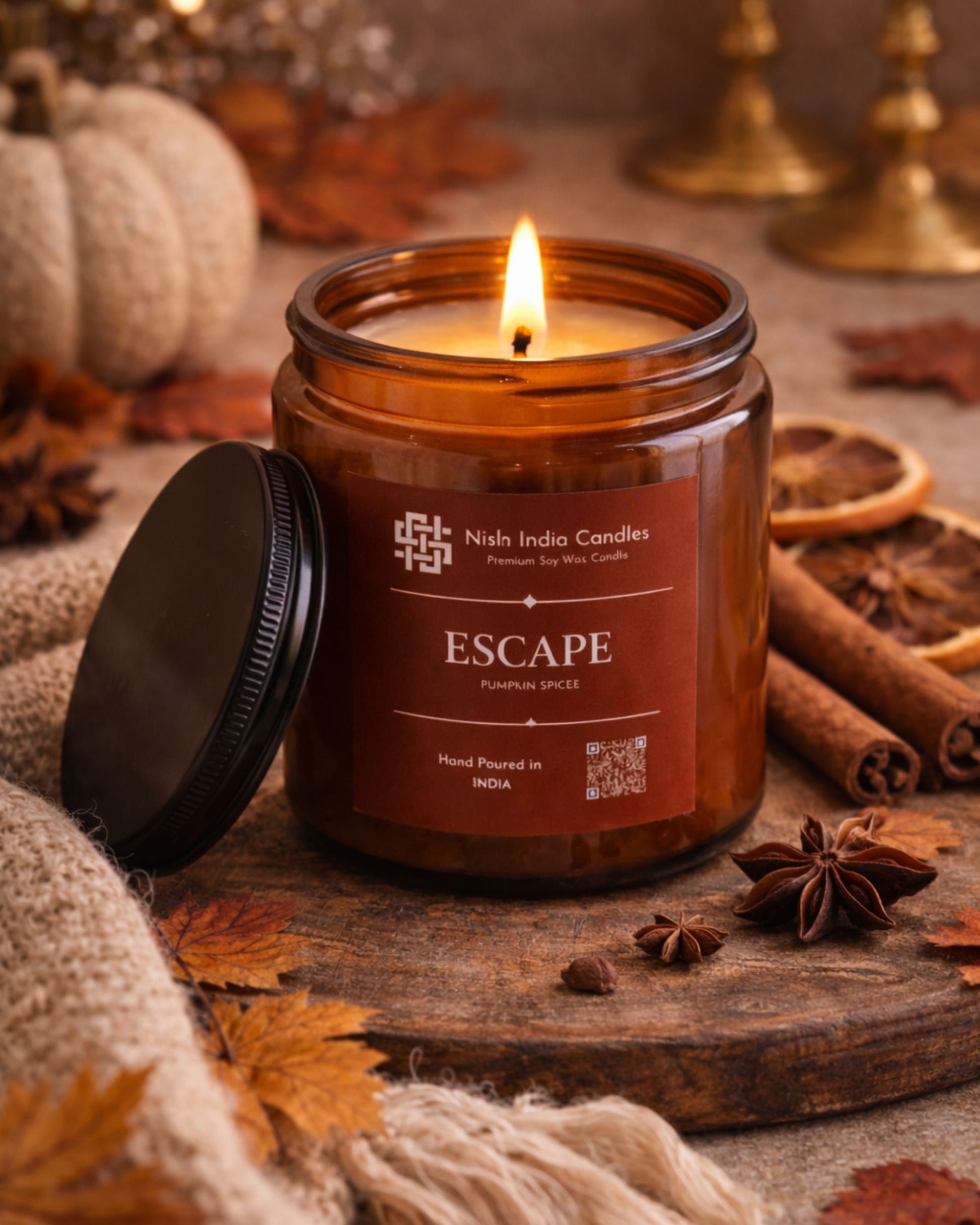Luxury Pumpkin Spice aromatherapy soy candle in amber glass jar surrounded by cinnamon and star anise for a warm relaxing autumn atmosphere.