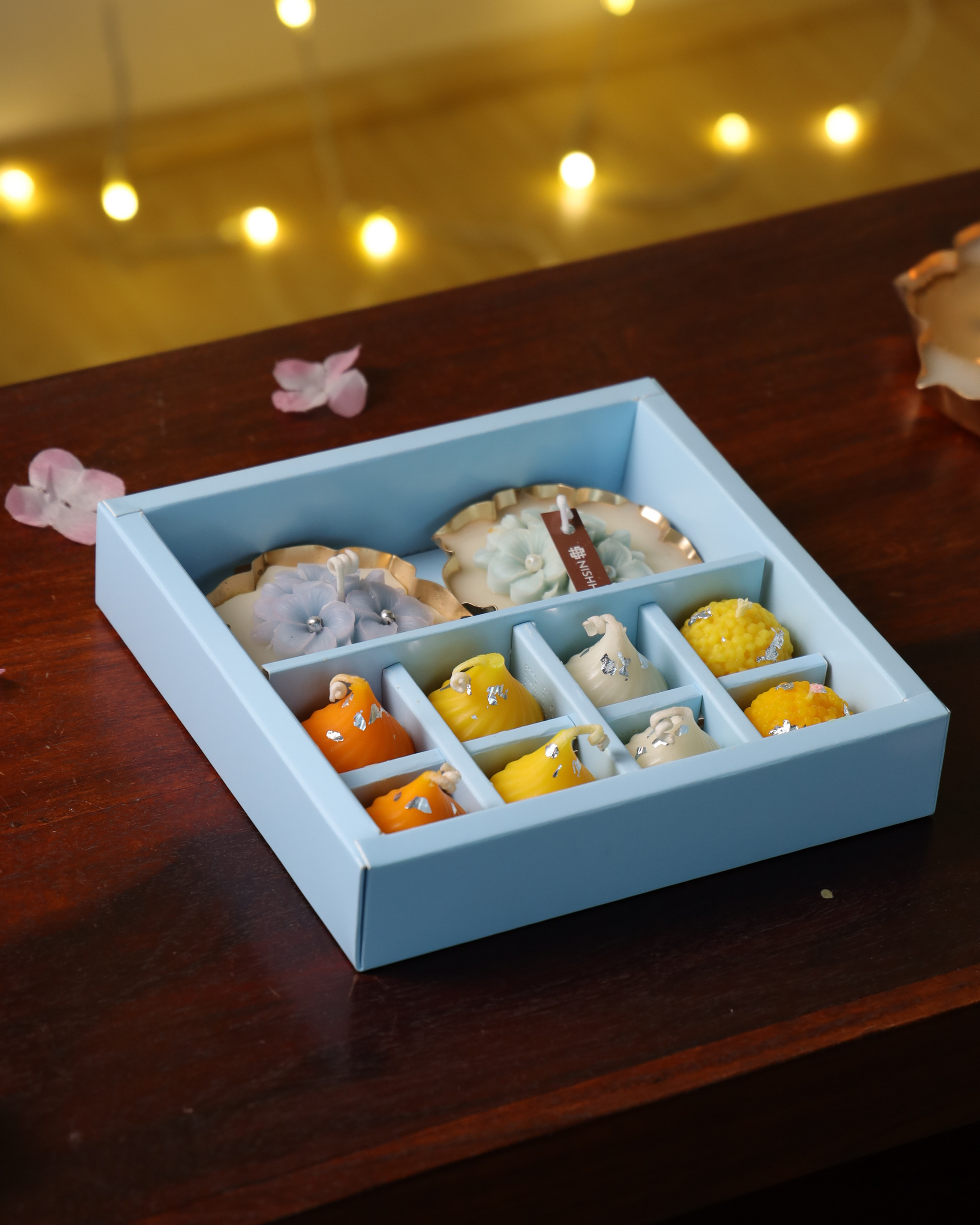 Pair of handcrafted urli candles with plumeria flower detailing – centerpiece of Shubh Aarambh Gift Set.